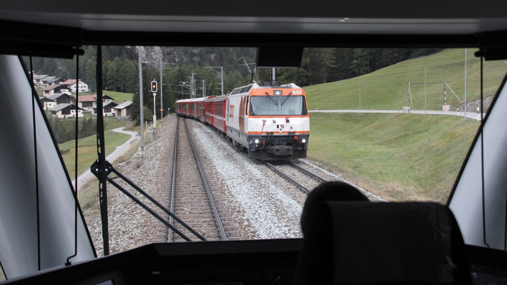 View through window behind cab of trains meeting