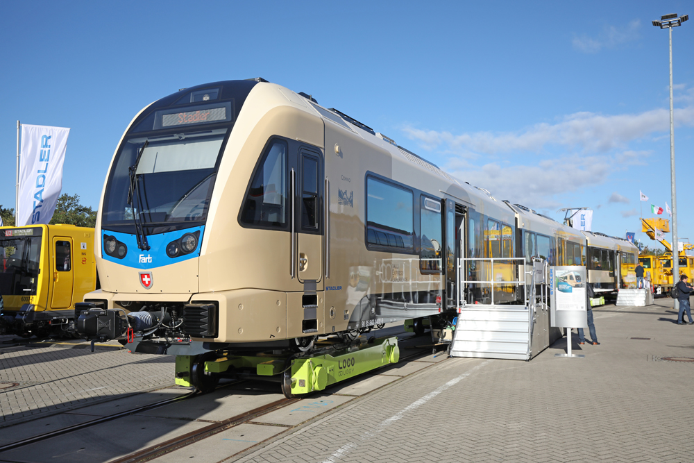 Golden-colored meter-gauge EMU, on trucks allowing it to be displayed on standard-gauge track