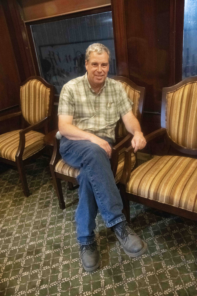 Man sitting in restored passenger car