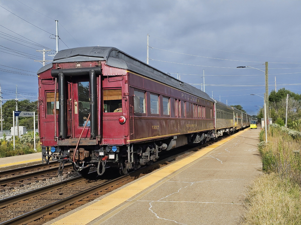 Red passenger car on back of Amtrak train