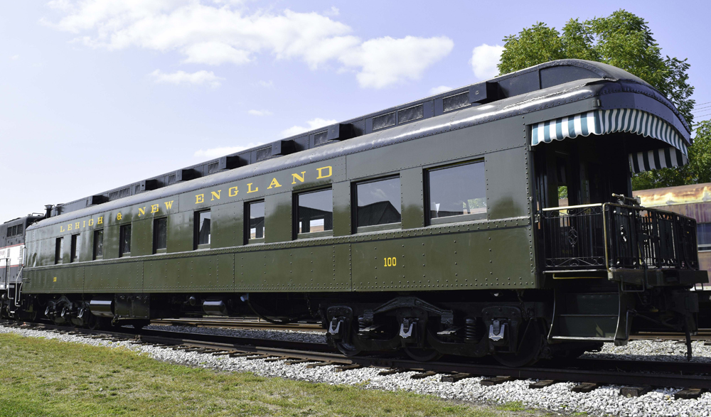 Dark green heavyweight passenger car with end platform