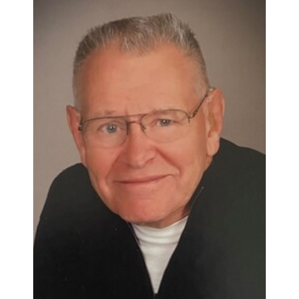 A picture of a man wearing glasses and a black shirt