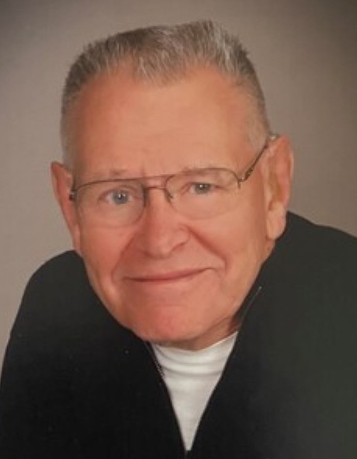 Head shot of man with short hair and glasses