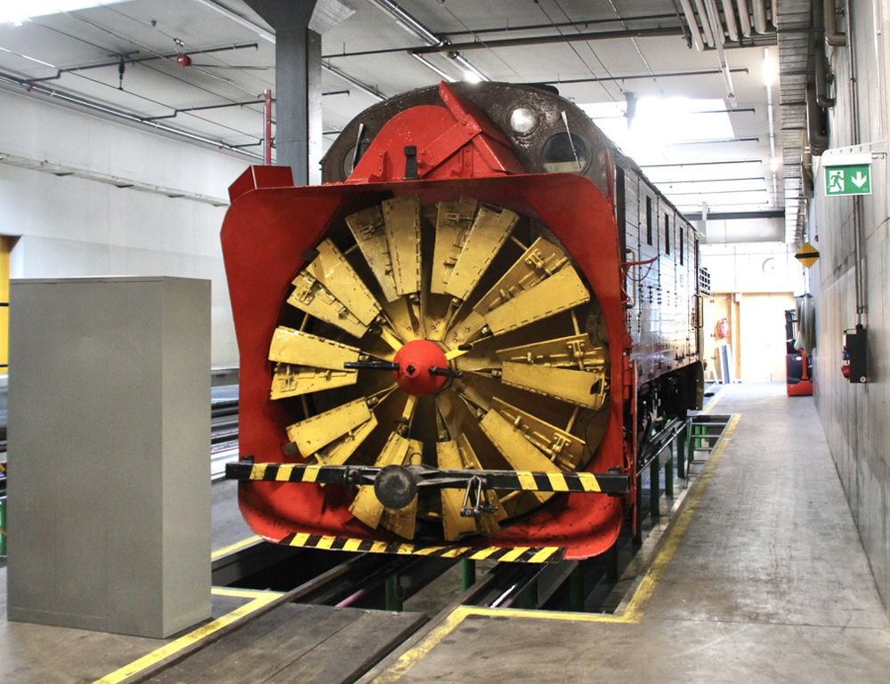 Front view of rotary snowplow in shop building