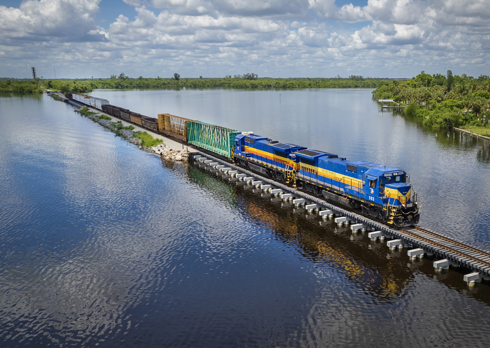 Train with two locomotives on long bridge