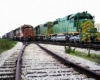 Diesel Illinois Terminal locomotives passing orange locomotives