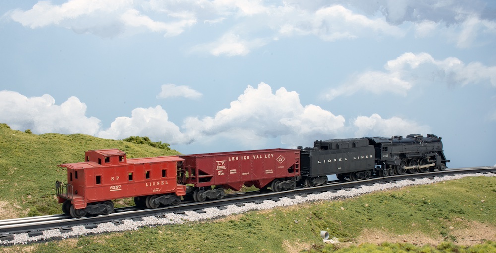 O gauge train on a scenic layout.