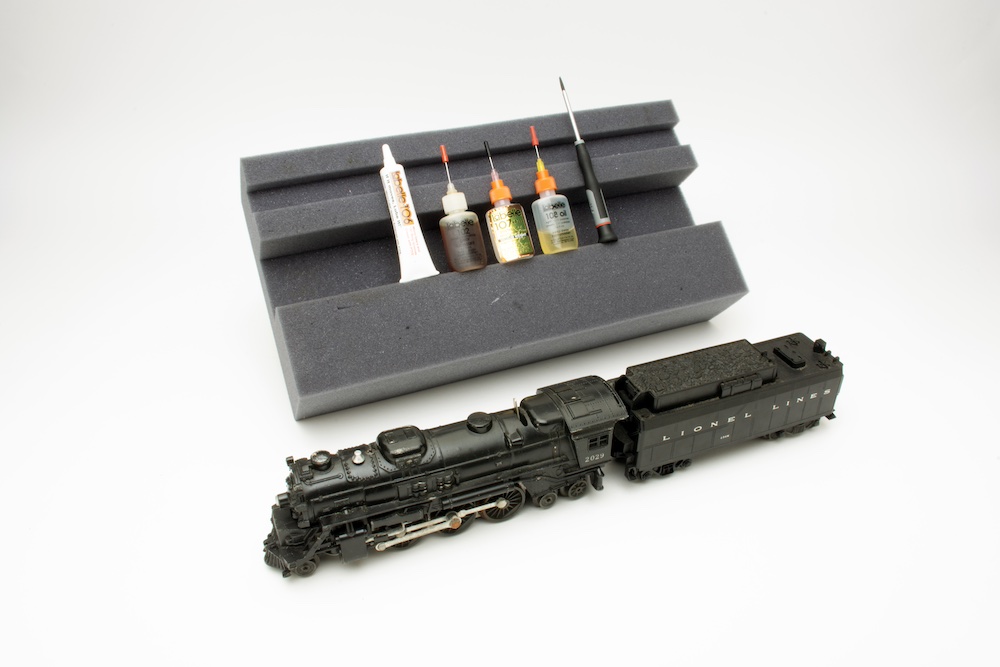 Model of vintage steam locomotive with maintenance kit.