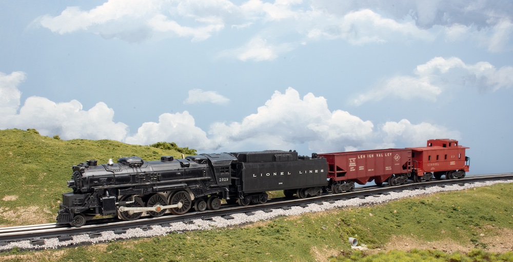 O gauge train on a scenic layout.