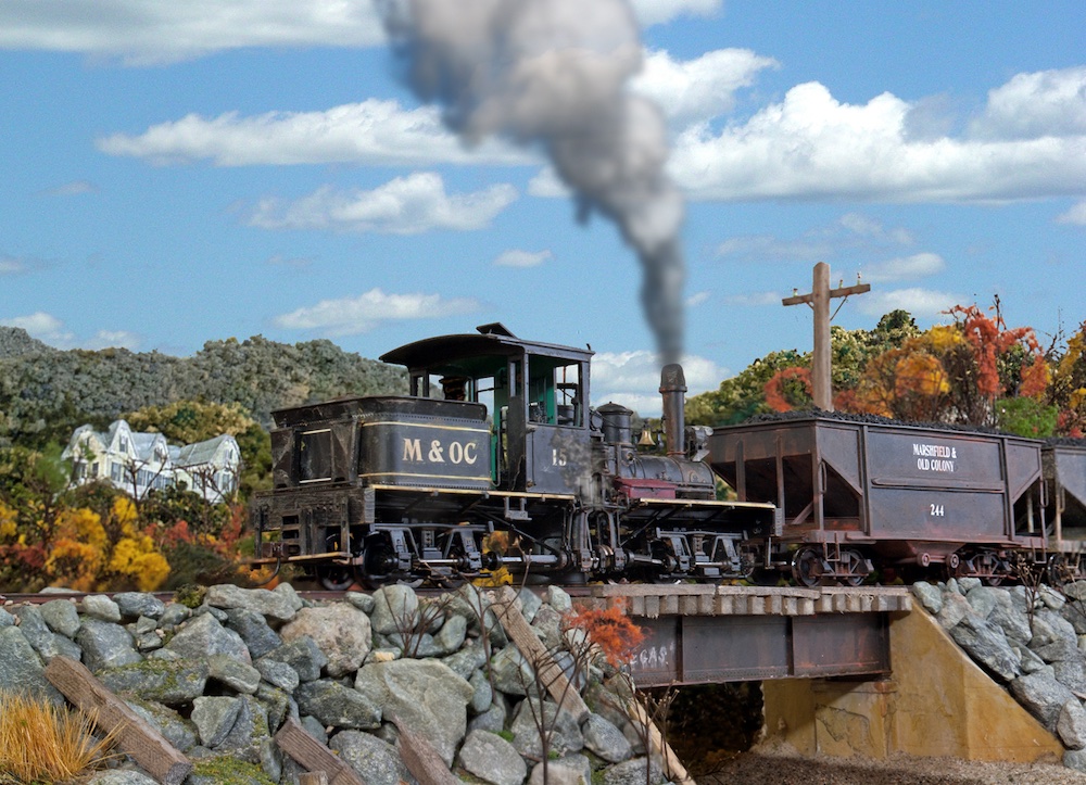 model steam locomotive crossing rocky bridge