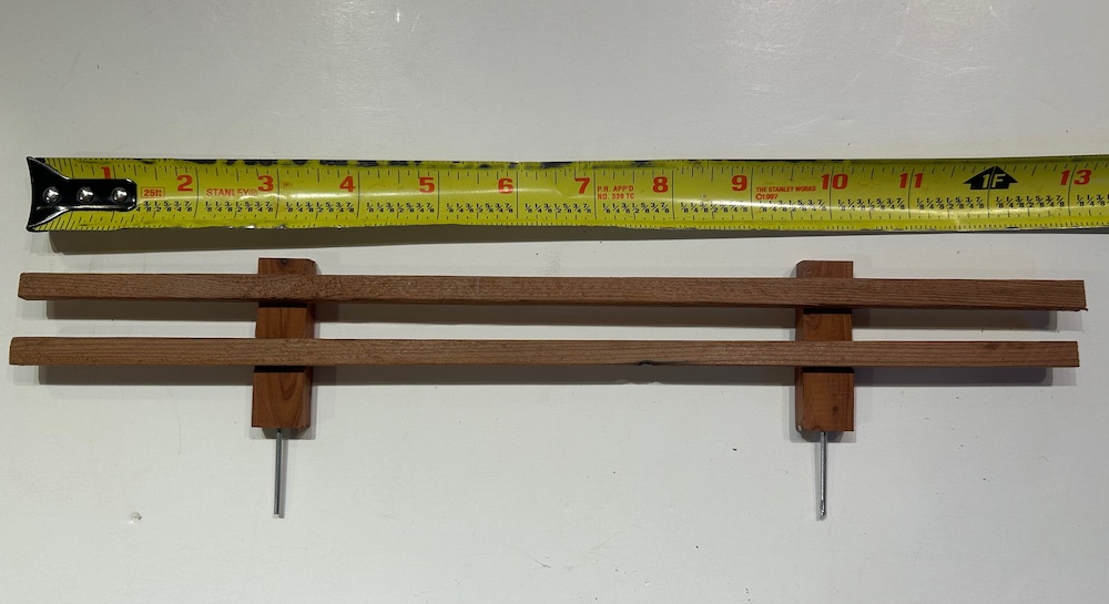 section of miniature fence with measuring tape next to it