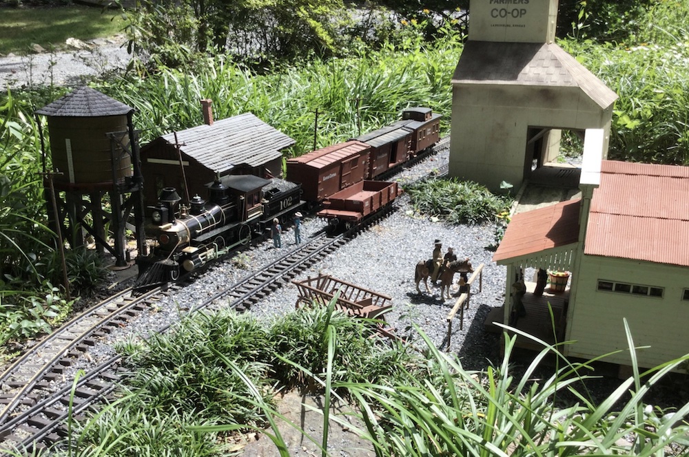 steam locomotive in scene on garden railroad; Capturing reality in garden railway photographs