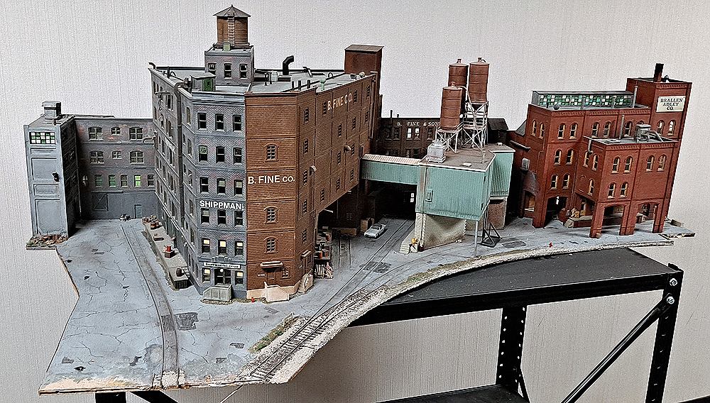 Structures from a model railroad attached to a thin base and removed from the layout