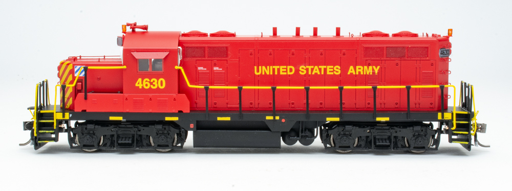 Color photo showing side of red-and-black HO diesel with yellow graphics.