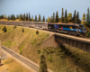 A black model locomotive leads a silver model passenger train across a bridge on a model railroad layout