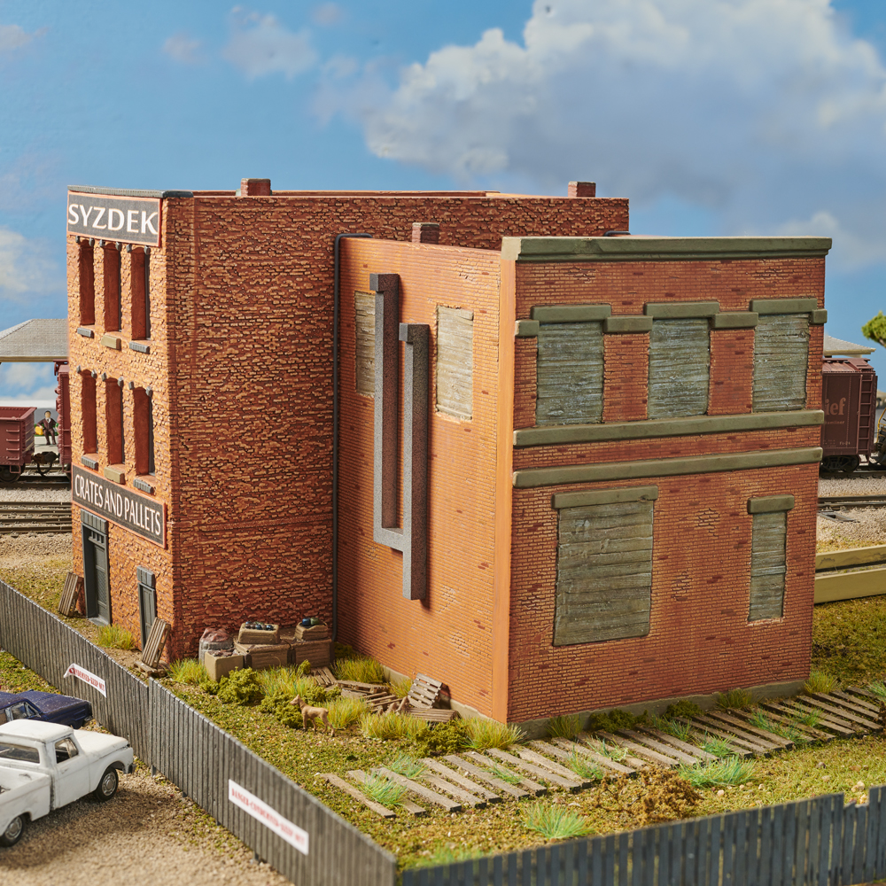 Color photo showing abandoned brick building on HO scale layout.