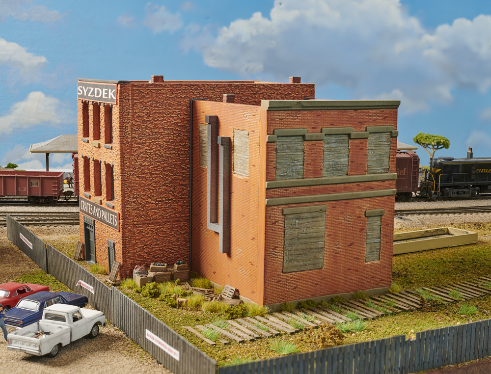 Color photo showing abandoned brick building on HO scale layout.