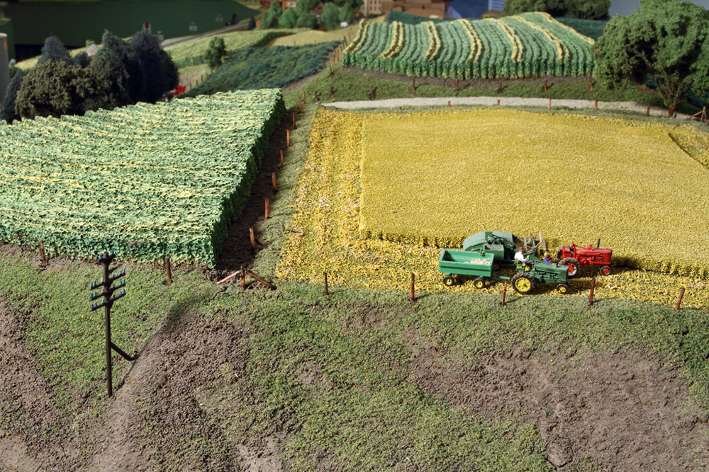 Color image showing farm fields on N scale model railroad.