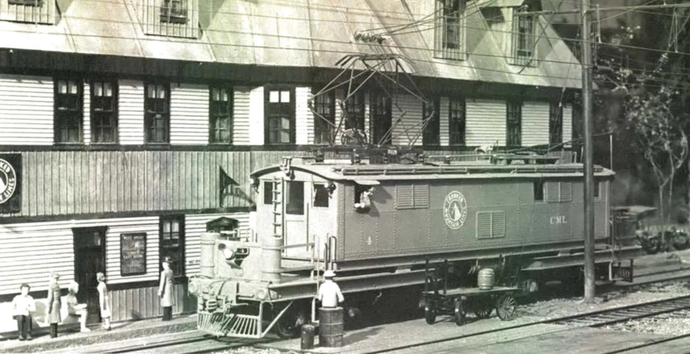 Black-and-white photo of model train in a box shape