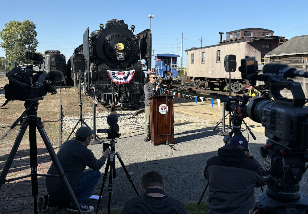 Press conference in front of steam locomotive as part of New York Central Mohawk No. 3001 joins Fort Wayne Railroad Historical Society fleet for potential return to steam