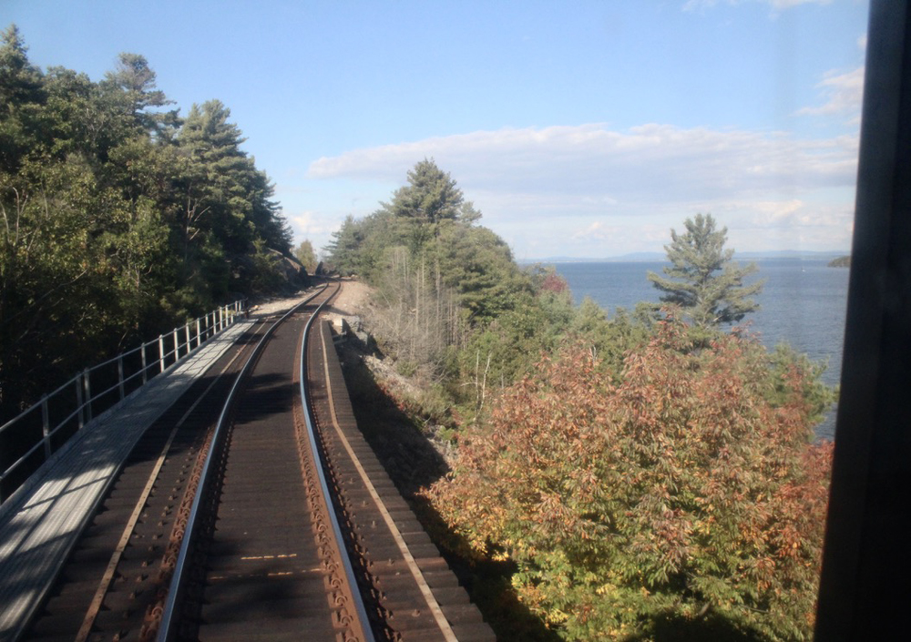 View of bridge from rear window of train's last car