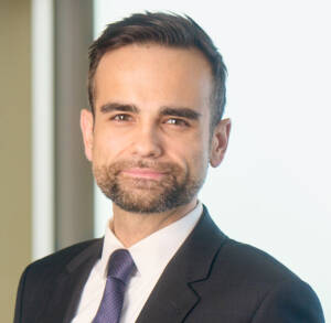 Head shot of bearded man in coat and tie