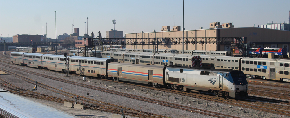 Five-car passenger train passing through Amtrak yard in Chicago