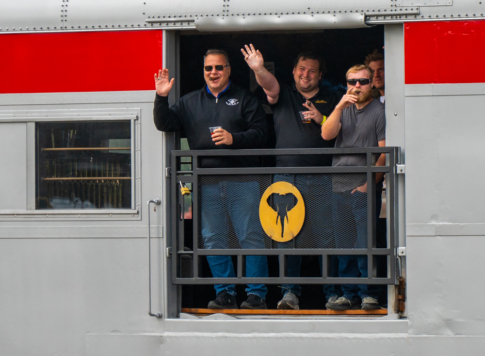 People in open door of railroad car