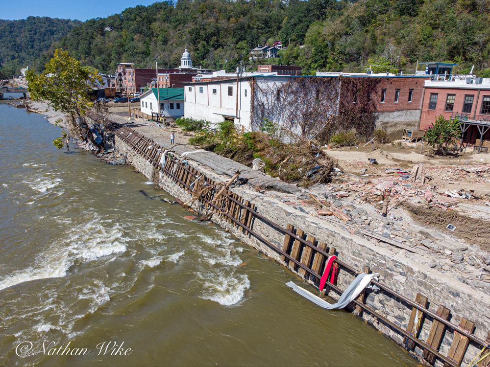 Rail line dangling along river bank