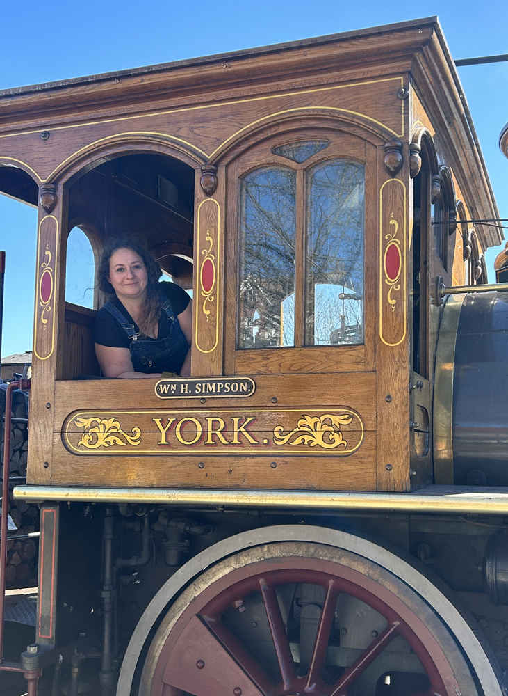 Woman in cab of steam locomotive