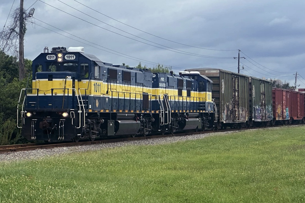 Blue and yellow locomotives with boxcars