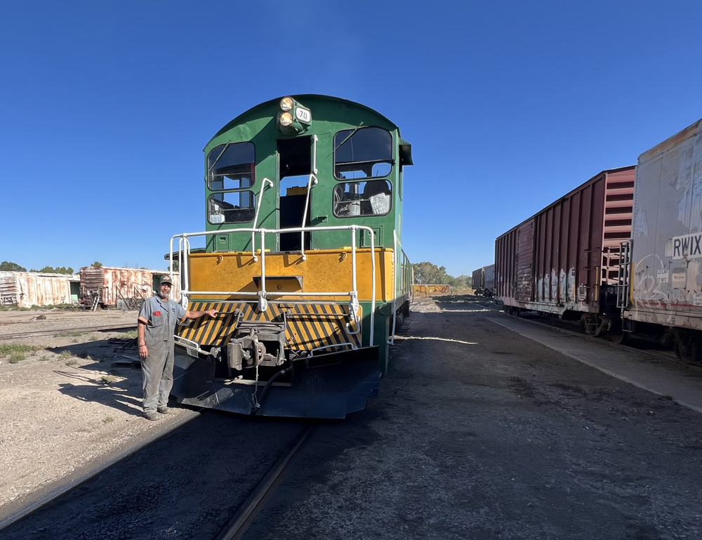 Green and yellow switch engine and crew member