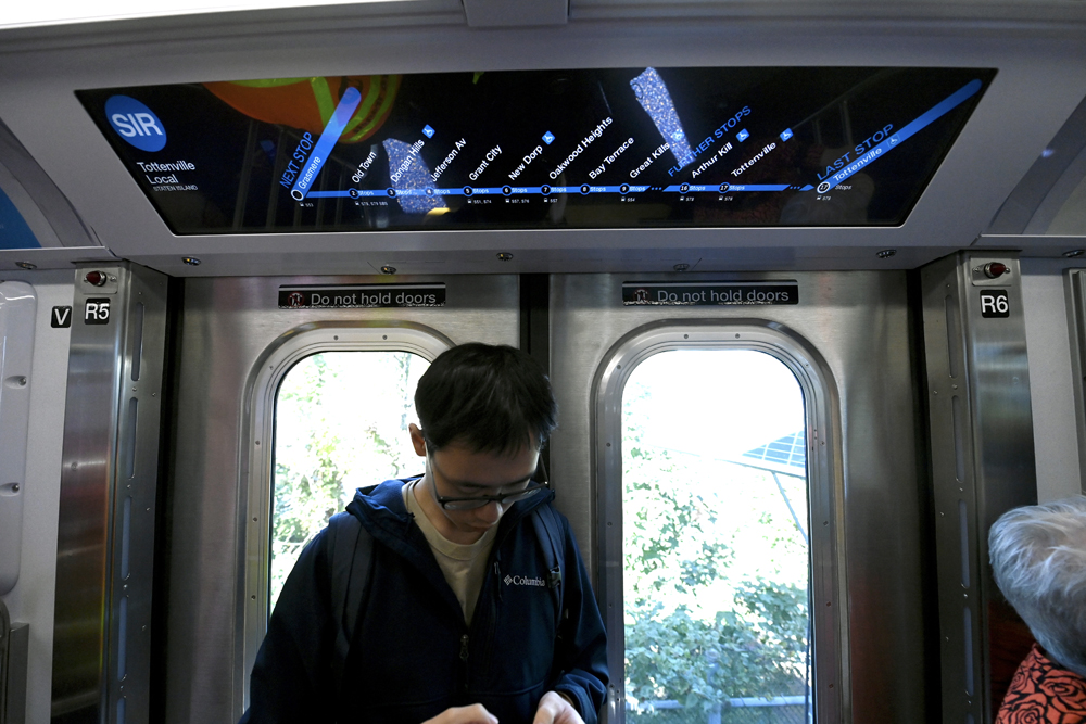 Digital display showing route information inside subway car