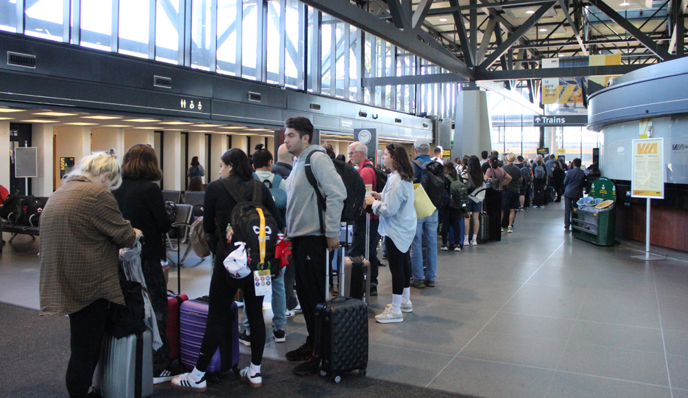 People standing in line in railroad station