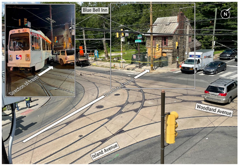 View of intersection with trolley tracks, with inset of derailed trolley