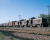 Black Burlington Route diesel locomotives with freight train on embankment