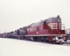 Burlington Route diesel locomotives one red and one black with freight train in snow