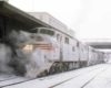 Streamlined Burlington Route diesel locomotives in station with passenger train