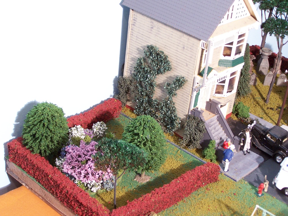 view of model house with garden on the side