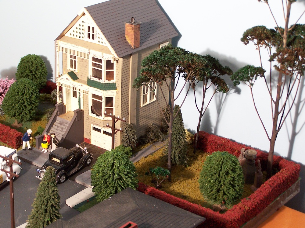 view of model house with trees and garden