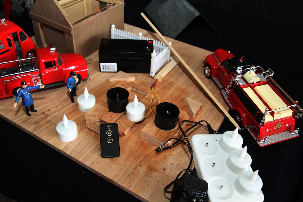 smoke units and LED candle lights on a wooden board