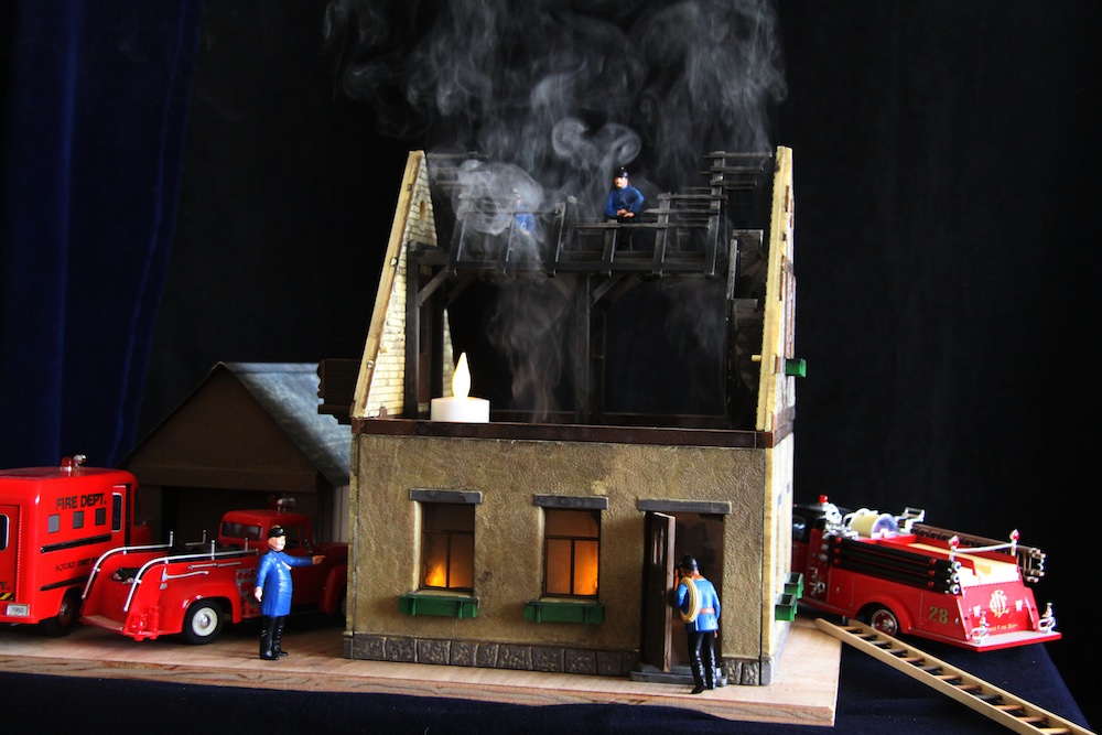 model of burning house with roof removed