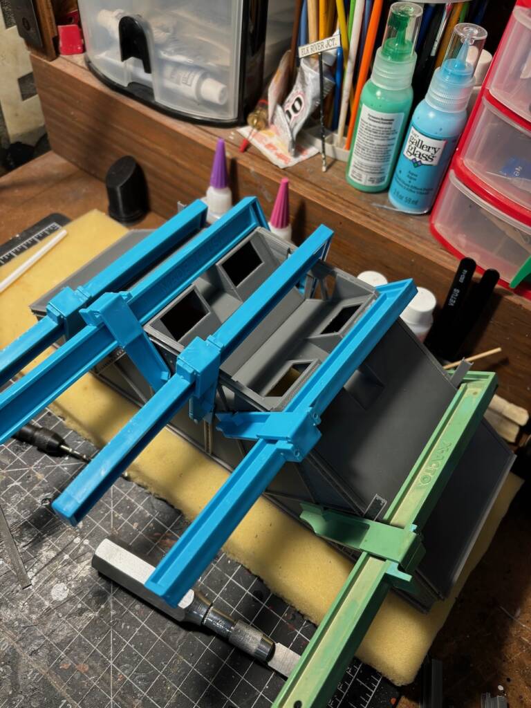 model car on workbench with clamps