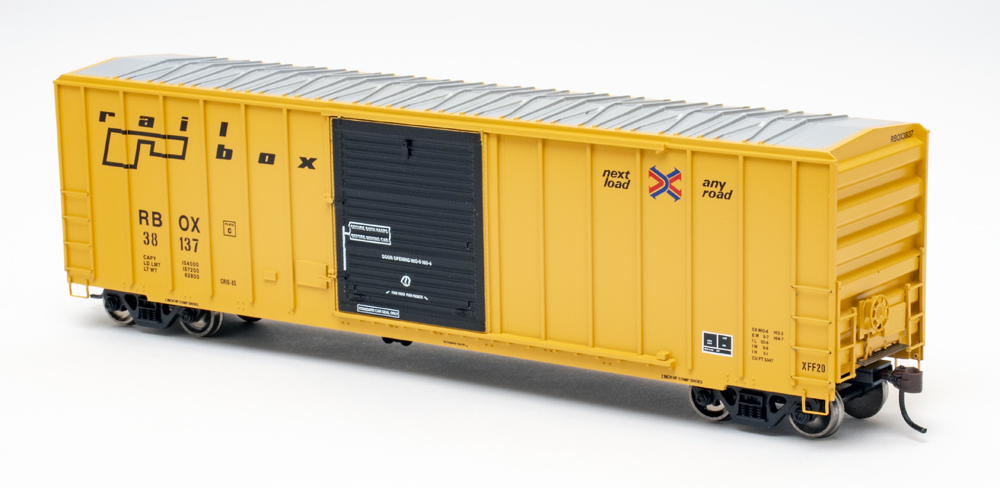 Color photo of yellow HO scale boxcar with black door and silver roof.