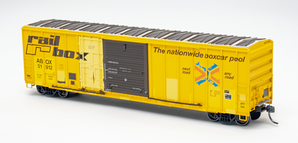 Color photo of HO scale boxcar painted yellow with black door and weathering.