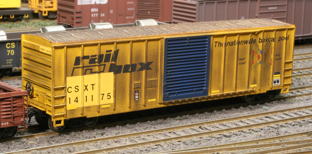 Color photo of HO scale Railbox car in a yard scene.