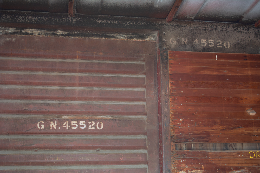 Color photo showing inside of boxcar.