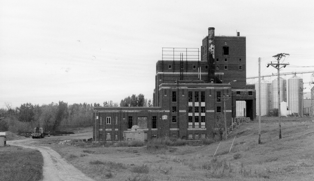 Black-and-white photo of abandoned power plant.