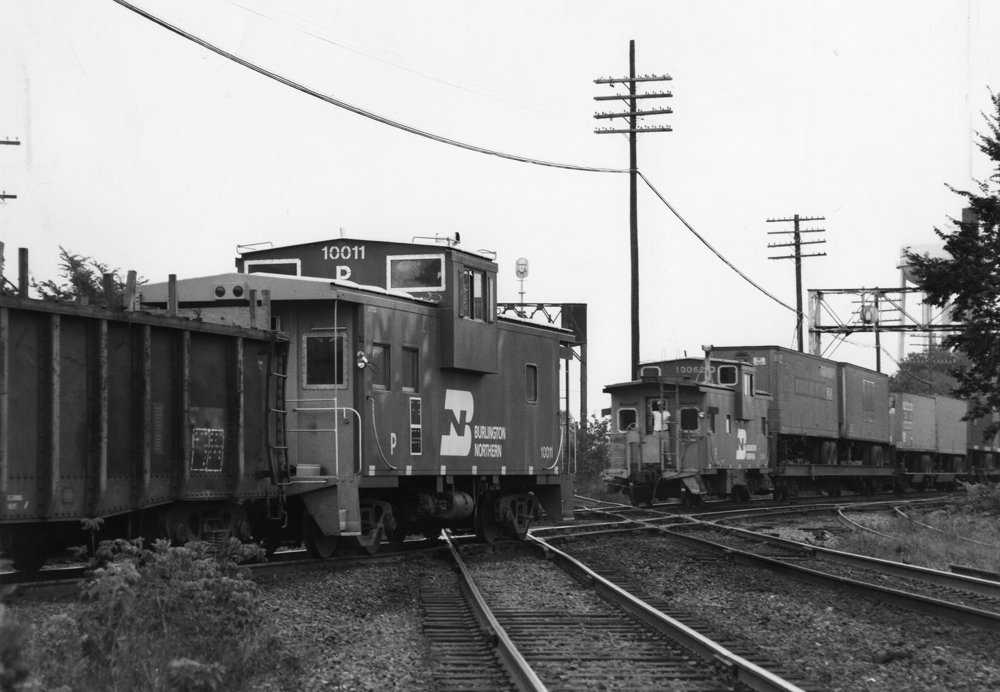 Black-and-white photo of two pool cabooses passing each other.