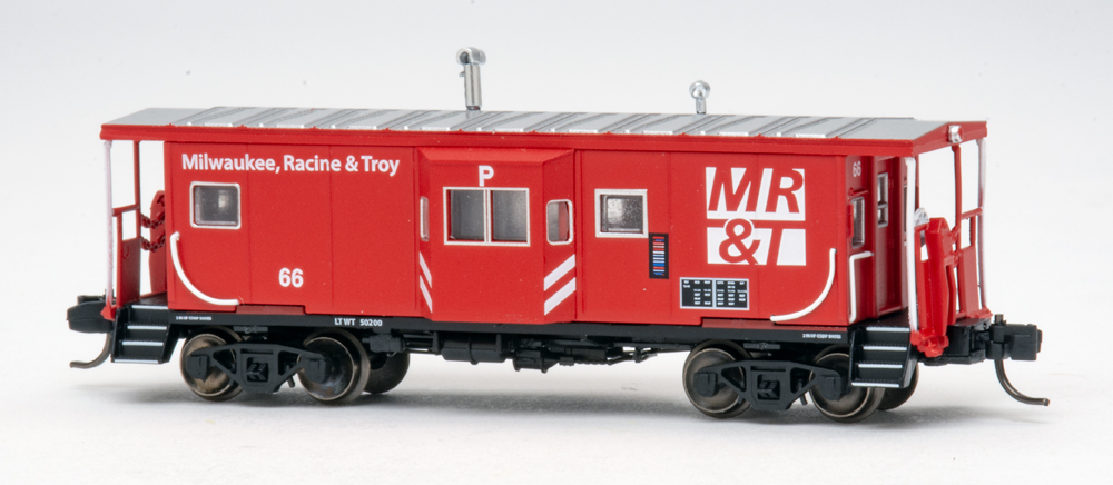 Color photo of N scale caboose painted red, black, and silver.